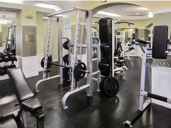 7320 Westpointe Blvd Unit 531, Orlando, FL 32835 - workout area with arched walkways, ornamental molding, and a ceiling fan