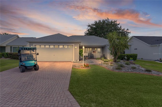 1305 Guerra Ave, The Villages, FL 32159 - ranch-style house featuring decorative driveway, a garage, and a lawn