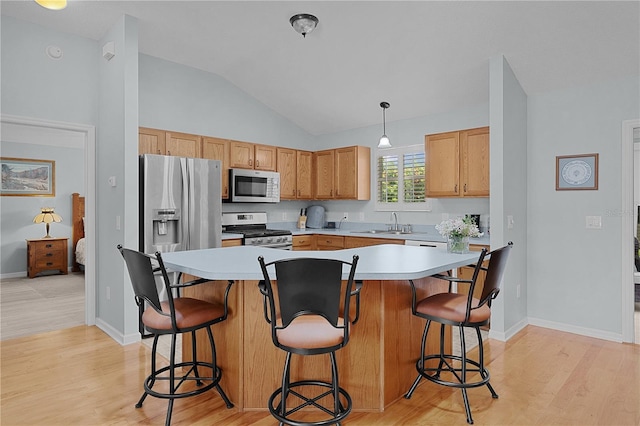 1305 Guerra Ave, The Villages, FL 32159 - kitchen with appliances with stainless steel finishes, lofted ceiling, light wood-style floors, light countertops, and a sink