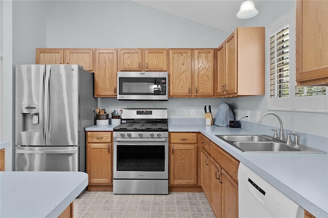 1305 Guerra Ave, The Villages, FL 32159 - kitchen with appliances with stainless steel finishes, a sink, light countertops, and lofted ceiling