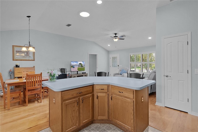 1305 Guerra Ave, The Villages, FL 32159 - kitchen with vaulted ceiling, light countertops, ceiling fan, recessed lighting, and light wood-style flooring