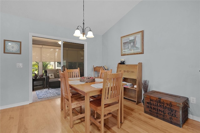 1305 Guerra Ave, The Villages, FL 32159 - dining room featuring lofted ceiling, baseboards, a chandelier, and light wood-type flooring