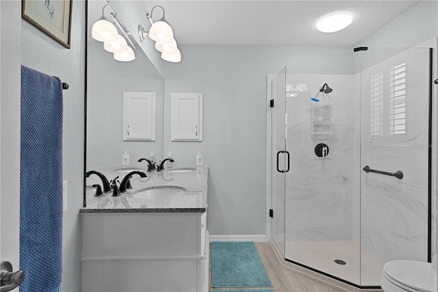1305 Guerra Ave, The Villages, FL 32159 - full bathroom with a marble finish shower, double vanity, toilet, wood finished floors, and baseboards