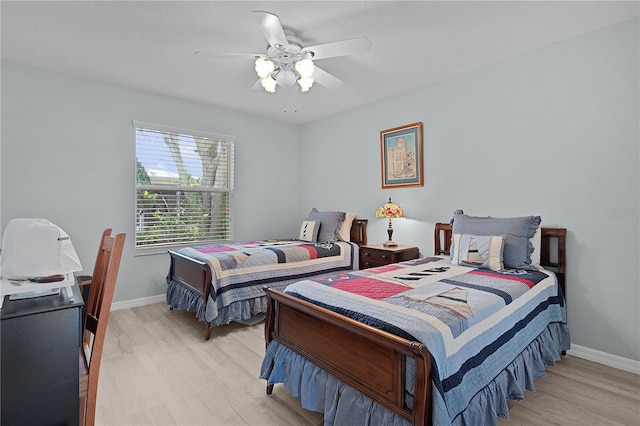 1305 Guerra Ave, The Villages, FL 32159 - bedroom featuring light wood-type flooring, baseboards, and a ceiling fan