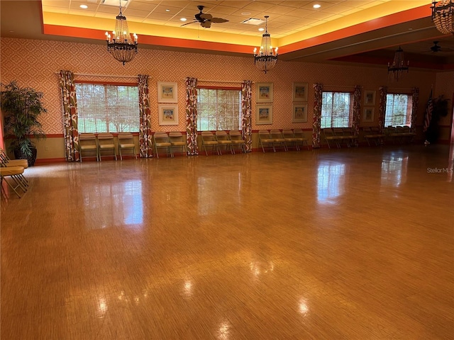 1305 Guerra Ave, The Villages, FL 32159 - miscellaneous room featuring a chandelier, a raised ceiling, wallpapered walls, wood finished floors, and wainscoting
