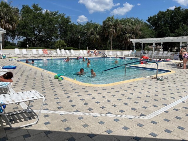 1305 Guerra Ave, The Villages, FL 32159 - community pool with a patio area and view of scattered trees