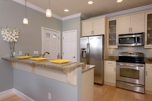 kitchen with stainless steel appliances, ornamental molding, a kitchen breakfast bar, a peninsula, and light stone counters