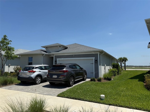 43819 Cattleman Dr, Punta Gorda, FL 33982 - view of side of home featuring driveway, a lawn, an attached garage, and stucco siding
