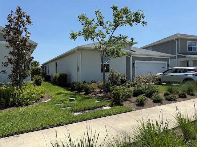 43819 Cattleman Dr, Punta Gorda, FL 33982 - view of front of home featuring a garage, stucco siding, and a front lawn