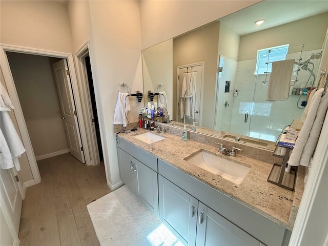 43819 Cattleman Dr, Punta Gorda, FL 33982 - bathroom with a stall shower, double vanity, wood finished floors, and baseboards