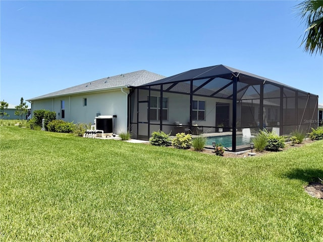 43819 Cattleman Dr, Punta Gorda, FL 33982 - rear view of property with central AC, a yard, stucco siding, an outdoor pool, and glass enclosure