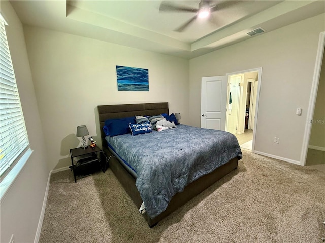43819 Cattleman Dr, Punta Gorda, FL 33982 - carpeted bedroom with baseboards, a tray ceiling, and a ceiling fan