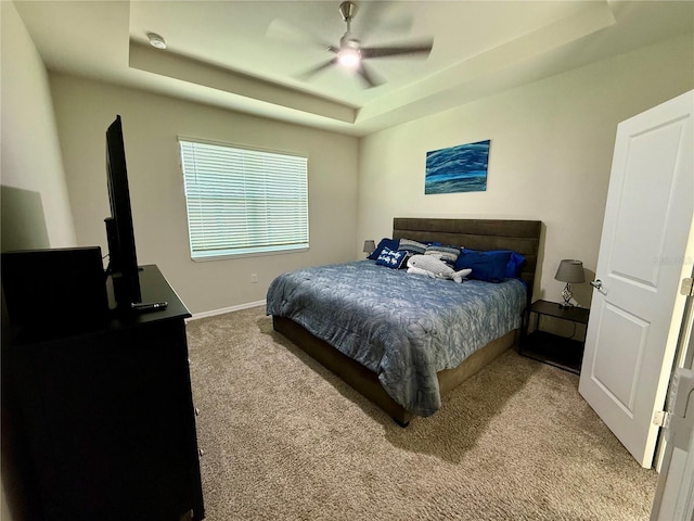 43819 Cattleman Dr, Punta Gorda, FL 33982 - carpeted bedroom featuring a tray ceiling, a ceiling fan, and baseboards