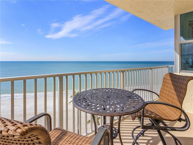 balcony with view of water and beach