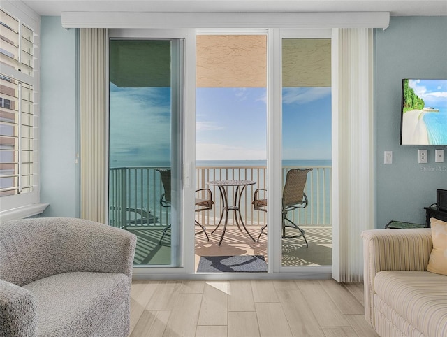 sitting room featuring wood finished floors and a water view