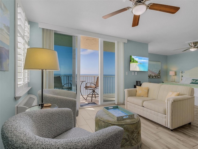 living room with a ceiling fan and wood finished floors
