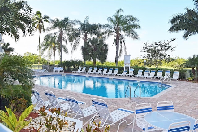 community pool featuring a patio area and fence