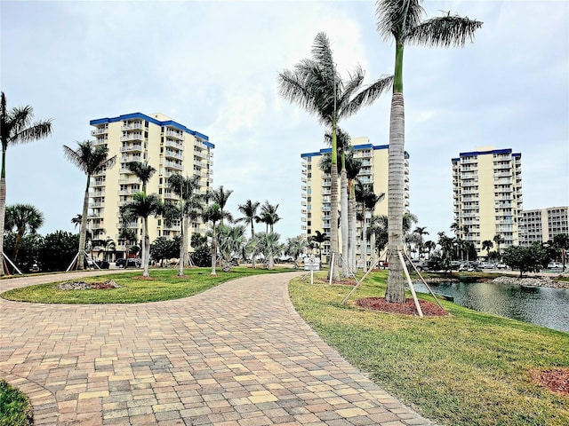 view of property's community featuring a water view and a lawn