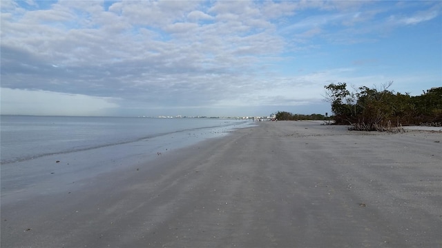 view of asphalt street with a water view