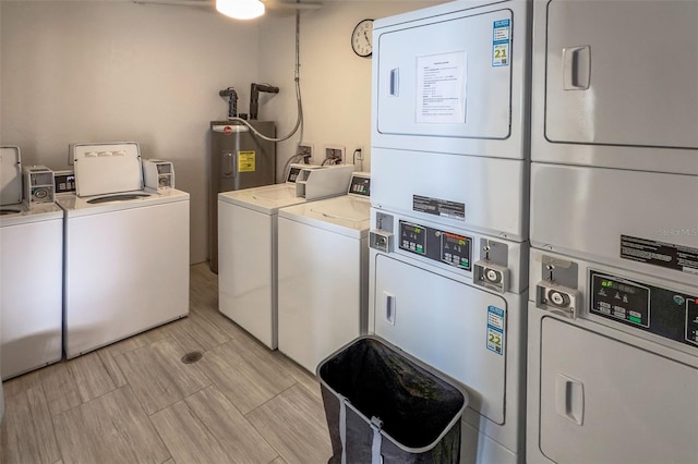 shared laundry room with stacked washer and clothes dryer, independent washer and dryer, and water heater