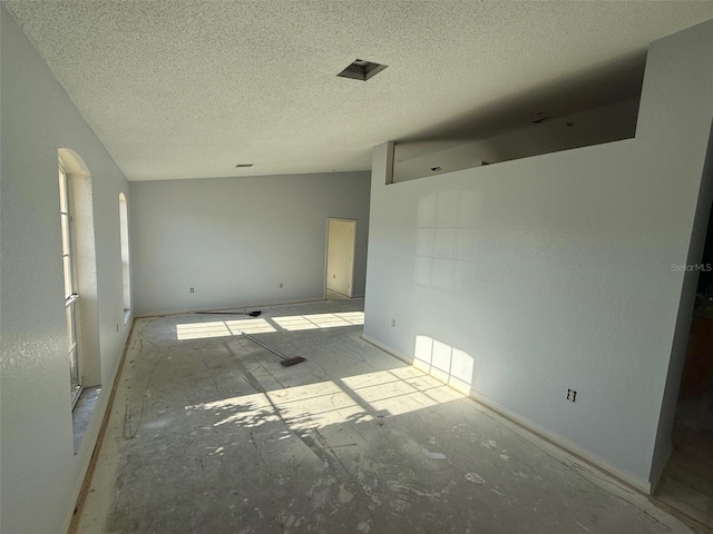 6608 Madeira Ave, Lakeland, FL 33811 - unfurnished bedroom featuring a textured ceiling and arched walkways