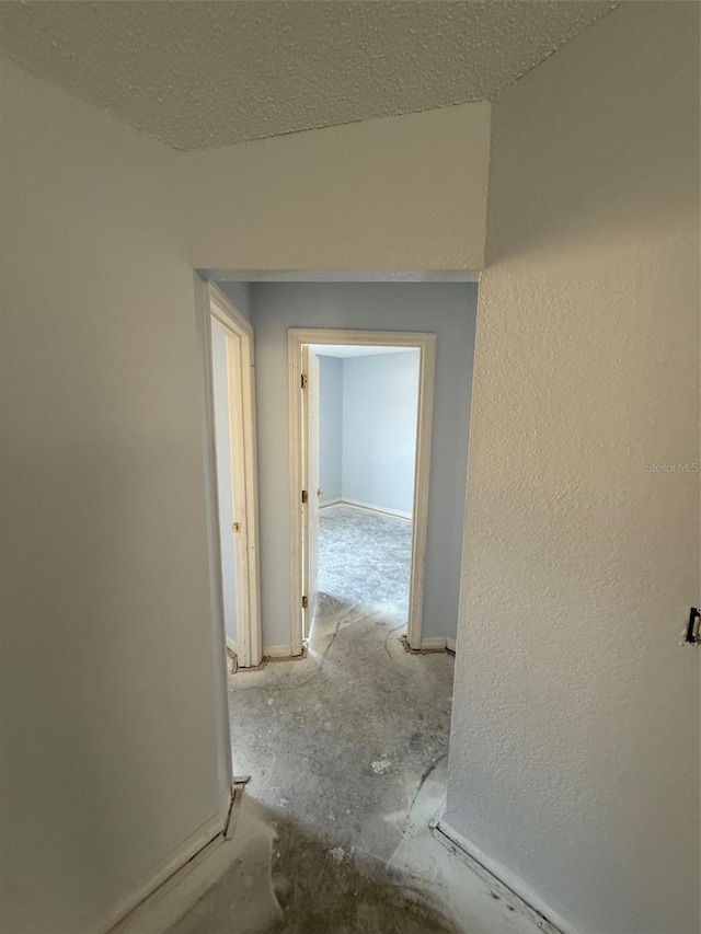 6608 Madeira Ave, Lakeland, FL 33811 - hall with baseboards and a textured ceiling