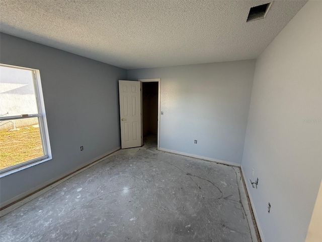6608 Madeira Ave, Lakeland, FL 33811 - spare room with baseboards and a textured ceiling
