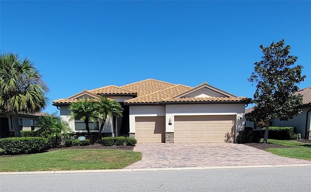 227 Heritage Preserve Run, Bradenton, FL 34212 - mediterranean / spanish house with an attached garage, stucco siding, driveway, and a tiled roof