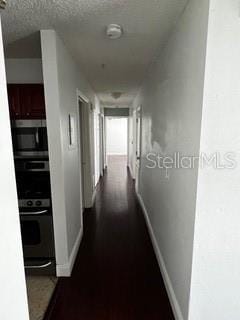 2013 Dixie Belle Dr Unit 2013K, Orlando, FL 32812 - hallway featuring baseboards and a textured ceiling