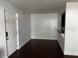 2013 Dixie Belle Dr Unit 2013K, Orlando, FL 32812 - corridor featuring baseboards and dark wood finished floors