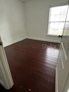 2013 Dixie Belle Dr Unit 2013K, Orlando, FL 32812 - unfurnished room with baseboards and wood finished floors