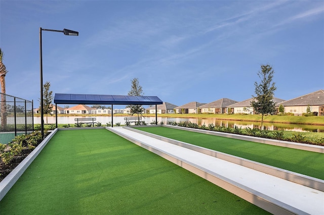surrounding community featuring a game area, a residential view, and a water view