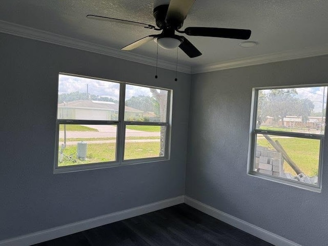 1426 Martin Luther King Jr Ave, Wauchula, FL 33873 - unfurnished room with dark wood finished floors, baseboards, plenty of natural light, a ceiling fan, and crown molding