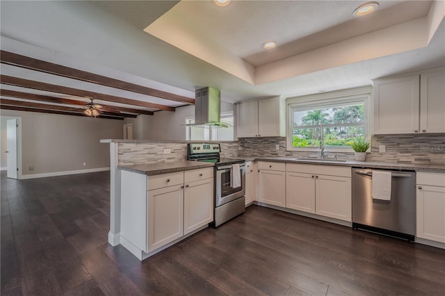 4514 Crichton Ln, Orlando, FL 32806 - kitchen with appliances with stainless steel finishes, island range hood, a peninsula, tasteful backsplash, and beam ceiling