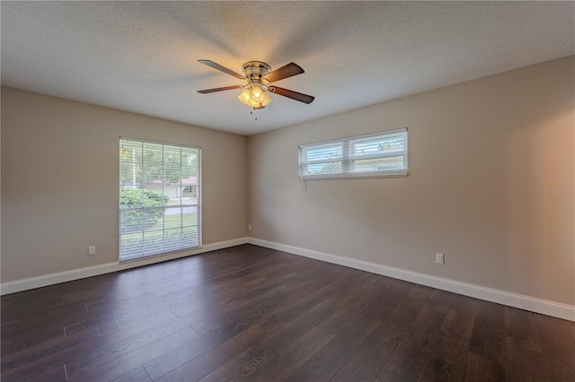 4514 Crichton Ln, Orlando, FL 32806 - spare room featuring a ceiling fan, dark wood finished floors, baseboards, and a textured ceiling
