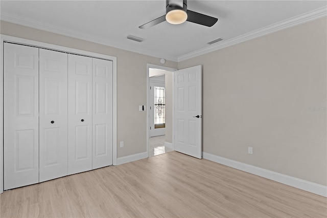 7214 SE 171st Brookhaven Pl, The Villages, FL 32162 - unfurnished bedroom with light wood-style floors, baseboards, a closet, crown molding, and ceiling fan