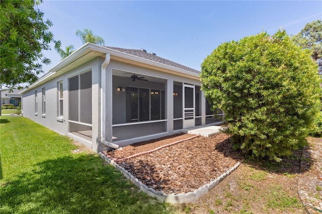 7214 SE 171st Brookhaven Pl, The Villages, FL 32162 - back of house with a sunroom, a yard, and stucco siding