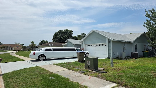 303 Silk Oak Dr, Kissimmee, FL 34743 - view of side of home featuring a garage, a yard, and cooling unit