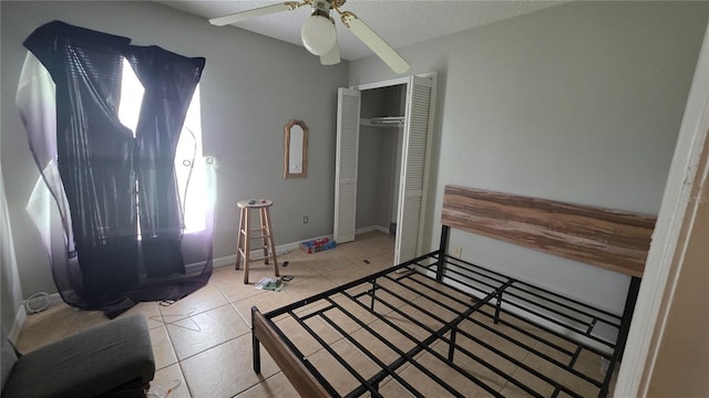 303 Silk Oak Dr, Kissimmee, FL 34743 - tiled bedroom featuring a closet, a ceiling fan, and a textured ceiling