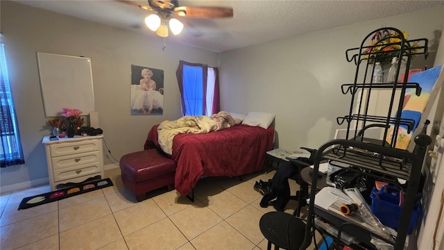 303 Silk Oak Dr, Kissimmee, FL 34743 - bedroom with light tile patterned flooring, a textured ceiling, and a ceiling fan