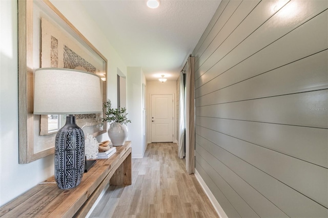 2046 Sunset Preserve Way, Port Charlotte, FL 33953 - hallway with light wood-type flooring, wooden walls, and baseboards