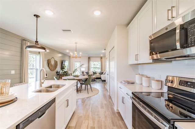 2046 Sunset Preserve Way, Port Charlotte, FL 33953 - kitchen featuring appliances with stainless steel finishes, a sink, light wood finished floors, white cabinets, and recessed lighting