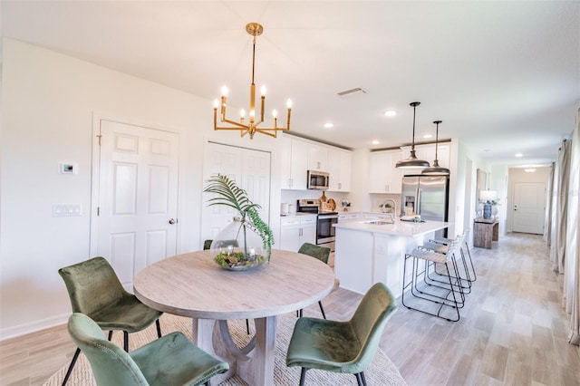 2046 Sunset Preserve Way, Port Charlotte, FL 33953 - dining area with light wood-style floors, a chandelier, baseboards, and recessed lighting