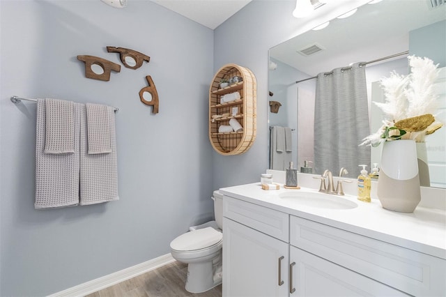2046 Sunset Preserve Way, Port Charlotte, FL 33953 - bathroom with toilet, vanity, wood finished floors, a shower with curtain, and baseboards