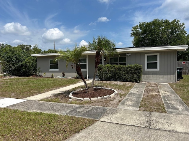 view of front of home with a front yard and concrete driveway