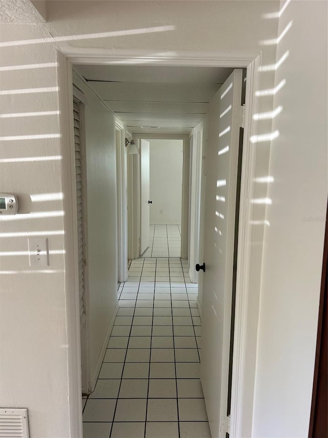 hall featuring light tile patterned floors