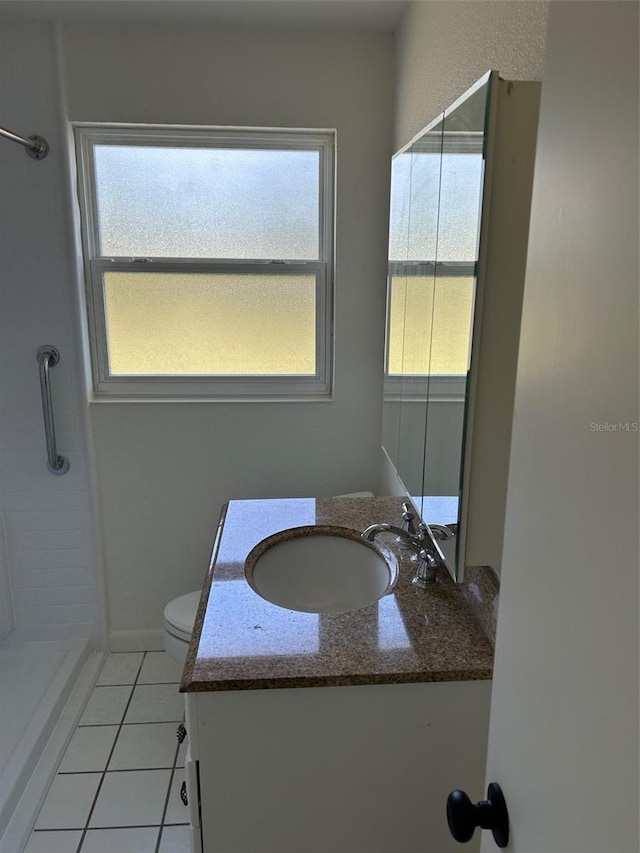 bathroom with vanity, toilet, healthy amount of natural light, and a shower