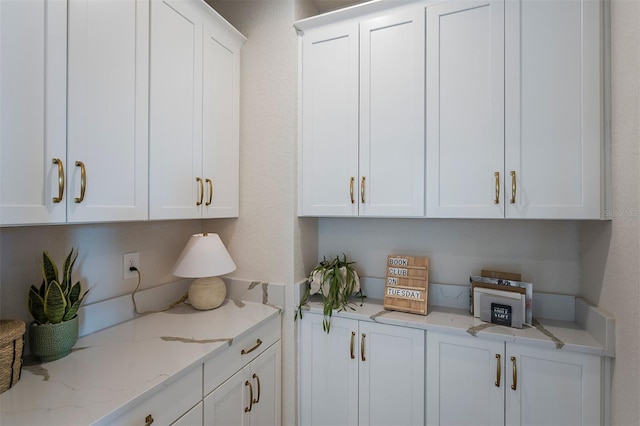 1688 Lugano Cir, North Venice, FL 34275 - kitchen featuring white cabinets and light stone countertops