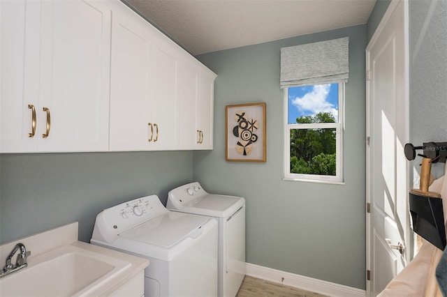 1688 Lugano Cir, North Venice, FL 34275 - laundry room featuring washer and clothes dryer, cabinet space, baseboards, and wood finished floors
