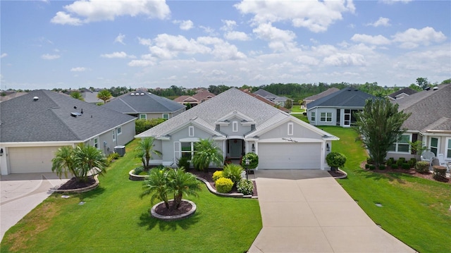 924 Figwood Loop, The Villages, FL 32163 - view of front of home with driveway, a residential view, a garage, a front yard, and stucco siding